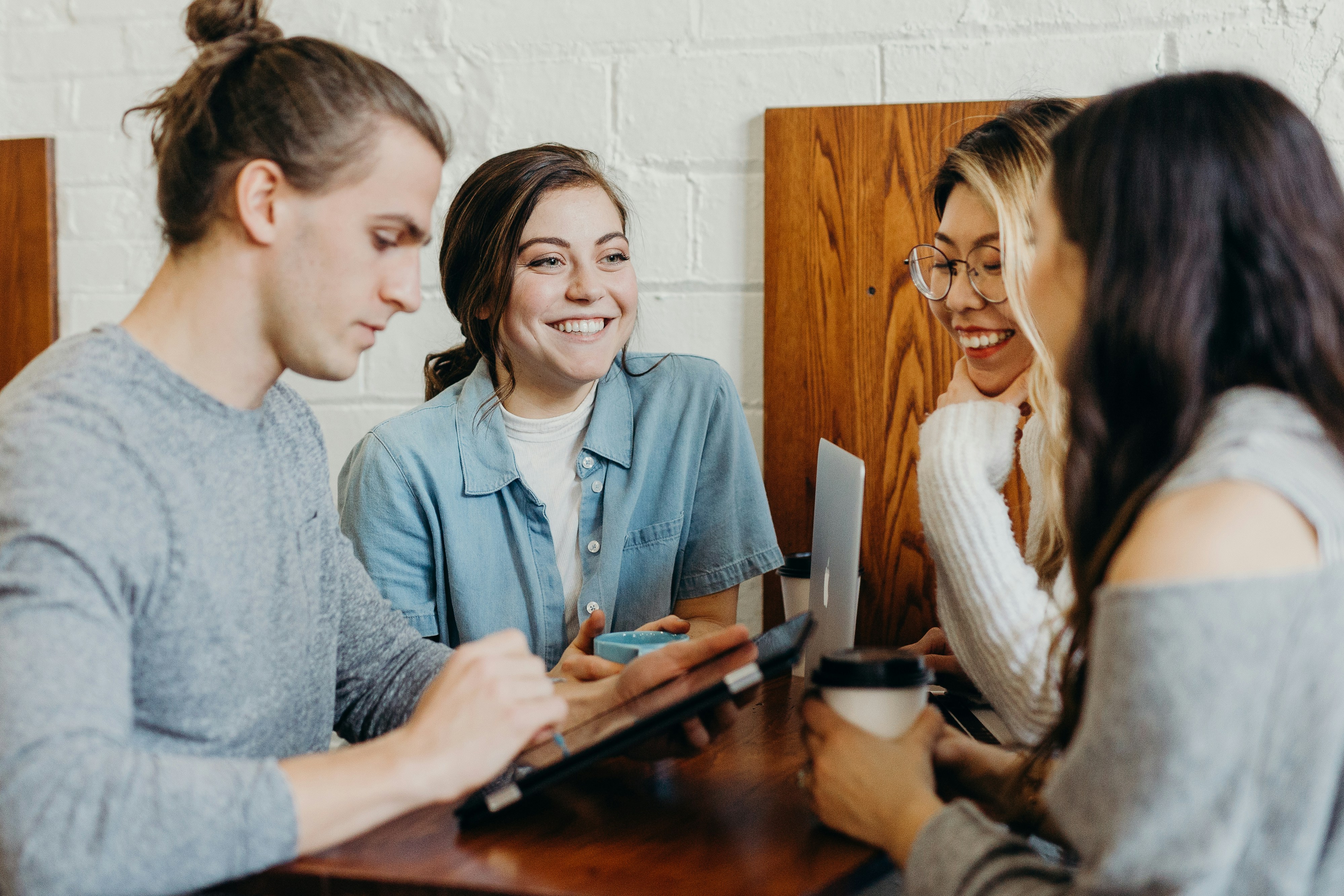 people smiling around a table