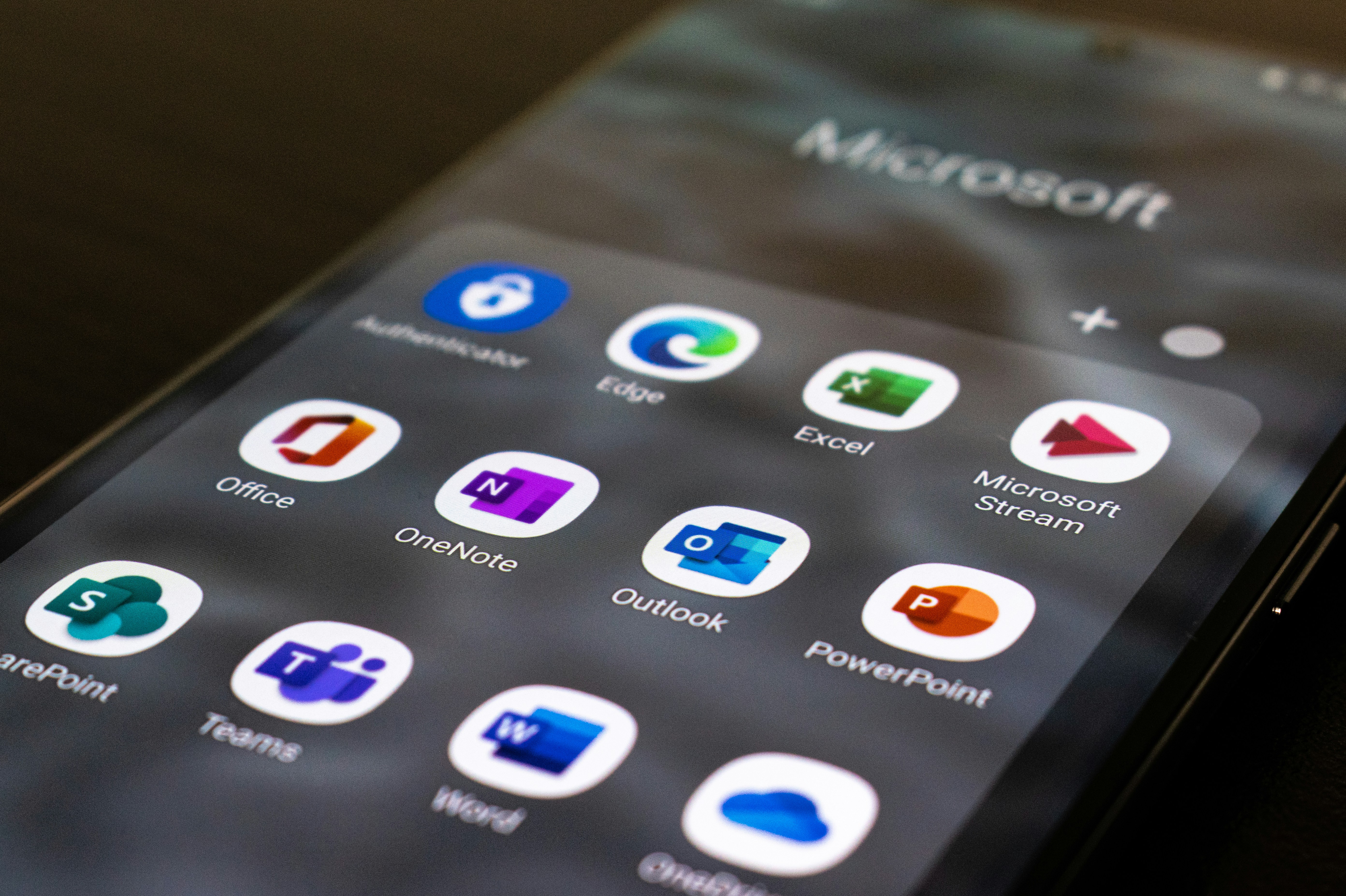 smartphone with icons for Microsoft apps